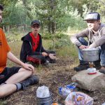 Alex cooking on a backpacking trip