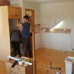 The boys helping to take apart the kitchen