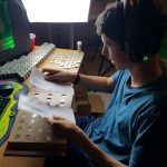 Alex sorting through 1000's of coins to fuel his love of coin collecting