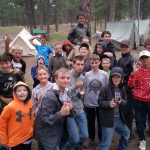 The entire troop back at camp - Eric is the one with the goofy look and a brother on his back!