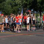 July - Michelle (blue tank top in middle) gets ready for the start of the local July 4th race.