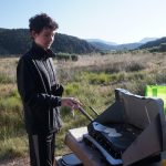 Alex cooking (burning) pancakes on a campout