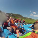 Eric (in orange) in the middle of a water fight on a rafting trip