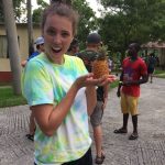 Janaye on a mission trip to Jamaica with her church - admiring a pygmy pineapple