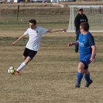April - Outdoor soccer has begun. Eric about to boot it!