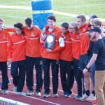 Alex holding their 2nd place trophy (missed 1st place by 1 point)